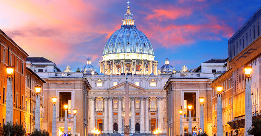 An evening shot of the St Peter's Basilica at the Vatican with its lights on